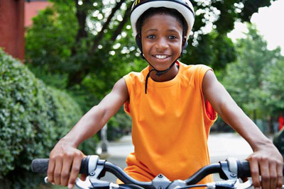 safe child preventing injury by wearing a helmet PHOTO